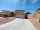 Inviting two-story home features a well-maintained yard and a spacious two-car garage at 11117 Okeefe Ct, Las Vegas, NV 89144