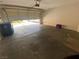Bright garage with an automatic door, concrete flooring, and space for vehicle and storage at 11117 Okeefe Ct, Las Vegas, NV 89144