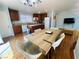 Eat-in kitchen has a large dining table, hardwood floors, an island, and modern appliances at 11117 Okeefe Ct, Las Vegas, NV 89144