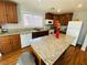 Well-lit kitchen boasts hardwood floors, granite countertops, modern appliances, and ample storage at 11117 Okeefe Ct, Las Vegas, NV 89144
