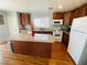 Traditional kitchen with island, stainless steel appliances, and wood-look flooring at 11117 Okeefe Ct, Las Vegas, NV 89144