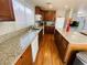 This updated kitchen has hardwood floors, granite countertops, an island, and stainless-steel appliances at 11117 Okeefe Ct, Las Vegas, NV 89144