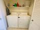 Functional laundry room with washer, dryer, storage shelf and tile floors at 11117 Okeefe Ct, Las Vegas, NV 89144