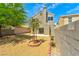 Fenced backyard with desert landscaping, trees, a patio, and a chimney at 1312 Pacific Terrace Dr, Las Vegas, NV 89128
