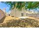 Fenced backyard with desert landscaping, trees, and a concrete patio at 1312 Pacific Terrace Dr, Las Vegas, NV 89128