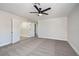 Spacious bedroom with plush carpet, ceiling fan, and double doors to bathroom and closet at 1312 Pacific Terrace Dr, Las Vegas, NV 89128