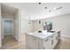 Bright kitchen with marble island, modern faucet, recessed lights, and open floor plan at 1312 Pacific Terrace Dr, Las Vegas, NV 89128