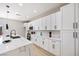 Modern kitchen with white cabinets, sleek countertops, and stainless steel microwave oven at 1312 Pacific Terrace Dr, Las Vegas, NV 89128