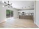 Open kitchen features white cabinets, a wood-paneled island, stainless appliances, and sliding door access to the backyard at 1312 Pacific Terrace Dr, Las Vegas, NV 89128