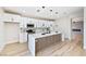 Spacious modern kitchen with white cabinets, island, and open layout to living area at 1312 Pacific Terrace Dr, Las Vegas, NV 89128
