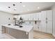 Bright kitchen featuring a marble island, stainless steel faucet, and modern lighting at 1312 Pacific Terrace Dr, Las Vegas, NV 89128