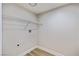 A bright laundry room features wood-look floors and a wire rack for storage at 1312 Pacific Terrace Dr, Las Vegas, NV 89128