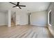 Open floor plan with wood-style floors, stairs to upper level, and natural light from a window at 1312 Pacific Terrace Dr, Las Vegas, NV 89128