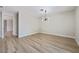 Open concept floor plan featuring wood floors and a modern light fixture at 1312 Pacific Terrace Dr, Las Vegas, NV 89128