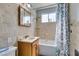 Tiled bathroom featuring a tub with shower, vanity and decorated shower curtain at 136 Elm St, Henderson, NV 89015
