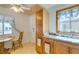 Eat-in kitchen with cabinets, a sink with large window, and a cozy breakfast nook at 136 Elm St, Henderson, NV 89015