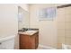 Bathroom featuring a wood vanity, granite countertop, and tiled shower at 1404 Atlantic St, Las Vegas, NV 89104