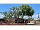 Charming single-story home featuring mature trees, a brick fence and a covered entrance at 1404 Atlantic St, Las Vegas, NV 89104