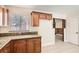 Kitchen showcasing wood cabinets, granite countertops, tile flooring and a bright window at 1404 Atlantic St, Las Vegas, NV 89104