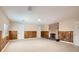 Spacious living room with brick fireplace, wood paneling, tile flooring, and bright lighting at 1404 Atlantic St, Las Vegas, NV 89104