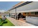Relaxing back patio area, featuring comfortable seating, a hot tub, and retractable awnings at 1413 Miller Ridge Ave, North Las Vegas, NV 89031