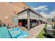 Inviting covered patio with comfortable seating, outdoor rug, and stylish retractable awning at 1413 Miller Ridge Ave, North Las Vegas, NV 89031