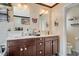 Bathroom with double vanity, modern mirrors, decorative art, and a convenient toilet alcove at 1413 Miller Ridge Ave, North Las Vegas, NV 89031
