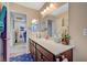 Updated bathroom with a stylish vanity, a large mirror, and updated fixtures throughout at 1413 Miller Ridge Ave, North Las Vegas, NV 89031