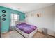 Comfortable bedroom with a plush bed, colorful decor, and a bright, airy feel from the natural light at 1413 Miller Ridge Ave, North Las Vegas, NV 89031