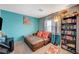 Bedroom with cozy seating, bookshelves, natural light, and a comfortable layout at 1413 Miller Ridge Ave, North Las Vegas, NV 89031