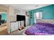 Bedroom with a TV, stylish furnishings, a comfortable bed, and creative wall decor at 1413 Miller Ridge Ave, North Las Vegas, NV 89031