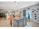 Open kitchen features an island with granite countertops and pendant lighting, plus dining area at 1413 Miller Ridge Ave, North Las Vegas, NV 89031