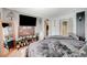 Spacious main bedroom with sleek furniture, a large TV, and walk-in closet access at 1413 Miller Ridge Ave, North Las Vegas, NV 89031