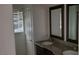 Bright bathroom features a double sink vanity with framed mirrors, complementing the natural light from the window at 1612 N Torrey Pines Dr # 104, Las Vegas, NV 89108