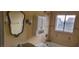 Bathroom with beige tiling, vanity with granite counter, and shower over tub at 1612 N Torrey Pines Dr # 104, Las Vegas, NV 89108