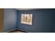 Bedroom with large window providing natural light and views of the backyard at 1612 N Torrey Pines Dr # 104, Las Vegas, NV 89108