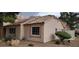 Exterior shot showcasing the tan stucco, red tile roof, and well-maintained landscaping at 1612 N Torrey Pines Dr # 104, Las Vegas, NV 89108