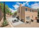 Large backyard with patio furniture, mature landscaping, and privacy fencing at 2057 Wandering Doe Ln, Las Vegas, NV 89134