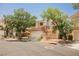 Charming two-story home with a well-maintained front yard and a two-car garage on a sunny day at 2057 Wandering Doe Ln, Las Vegas, NV 89134