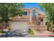 Charming two-story home with a well-maintained front yard and a two-car garage on a sunny day at 2057 Wandering Doe Ln, Las Vegas, NV 89134