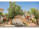 Charming two-story home with a well-maintained front yard and a two-car garage on a sunny day at 2057 Wandering Doe Ln, Las Vegas, NV 89134