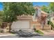 Charming two-story home with a well-maintained front yard and a two-car garage on a sunny day at 2057 Wandering Doe Ln, Las Vegas, NV 89134
