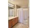 Clean bathroom featuring a vanity with sink, white shower curtain, and tile flooring at 23 E Agate Ave # 403, Las Vegas, NV 89123