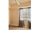 Bedroom with neutral carpet, ceiling fan, and a window with curtains for natural light at 23 E Agate Ave # 403, Las Vegas, NV 89123