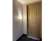A picture of unit 403's tan front door with a silver handle, and lit by a lamp to the side at 23 E Agate Ave # 403, Las Vegas, NV 89123