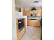 Kitchen showcasing light wood cabinets, granite countertops, stainless steel appliances, and tile floors at 23 E Agate Ave # 403, Las Vegas, NV 89123