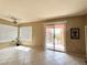 Sunlit living room showcasing tile floors, ceiling fan, and sliding door to the balcony at 23 E Agate Ave # 403, Las Vegas, NV 89123