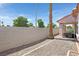 Spacious backyard featuring privacy wall, mature landscaping, and patio with grill at 2699 Aldonza Dr, Henderson, NV 89014