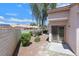 Landscaped backyard featuring a covered patio and mature shade trees at 2699 Aldonza Dr, Henderson, NV 89014