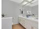 Bright bathroom with double sinks, fresh flowers, modern fixtures, and natural light at 2699 Aldonza Dr, Henderson, NV 89014